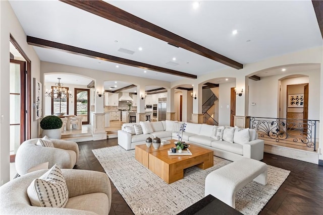 living room with arched walkways, beam ceiling, a notable chandelier, recessed lighting, and stairs