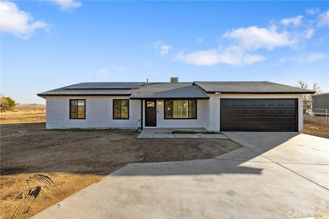 view of front of house featuring solar panels and a garage