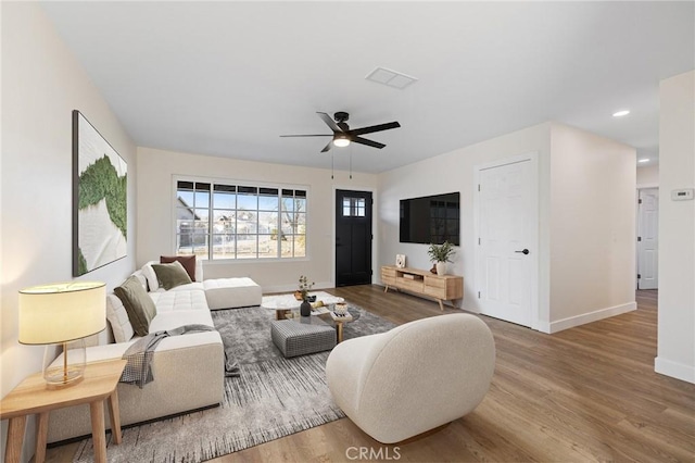 living room featuring ceiling fan and hardwood / wood-style floors