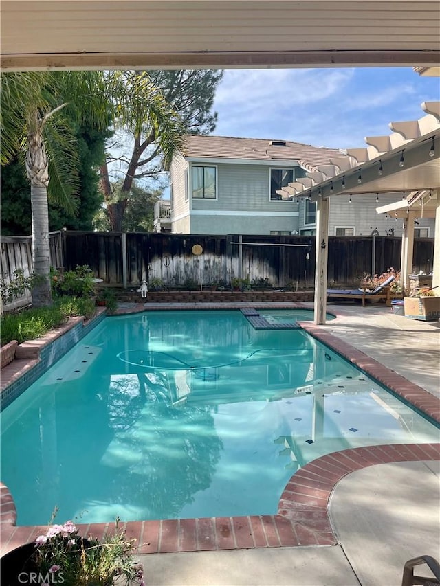 view of swimming pool featuring a fenced in pool, a patio area, a fenced backyard, and a pergola