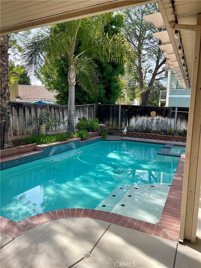 view of swimming pool with a fenced backyard and a fenced in pool