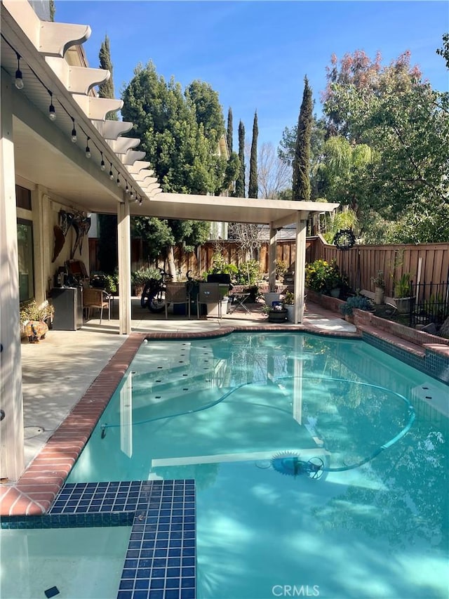 view of pool with a fenced in pool, a patio area, a fenced backyard, and a pergola