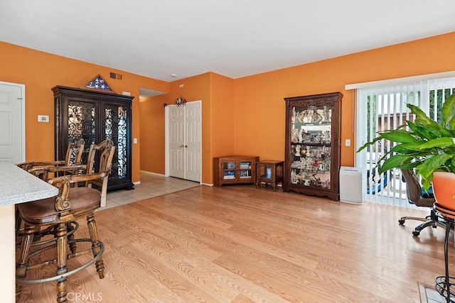 interior space with light wood-style flooring and visible vents