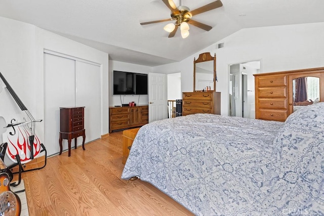 bedroom with light wood-style floors, visible vents, vaulted ceiling, and ceiling fan