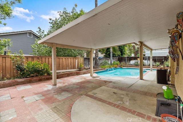 view of swimming pool featuring a fenced backyard, a fenced in pool, and a patio