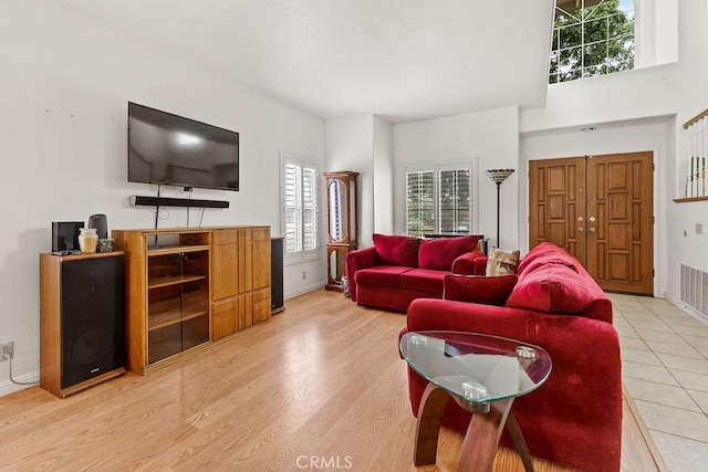 living area featuring light wood-style flooring and baseboards