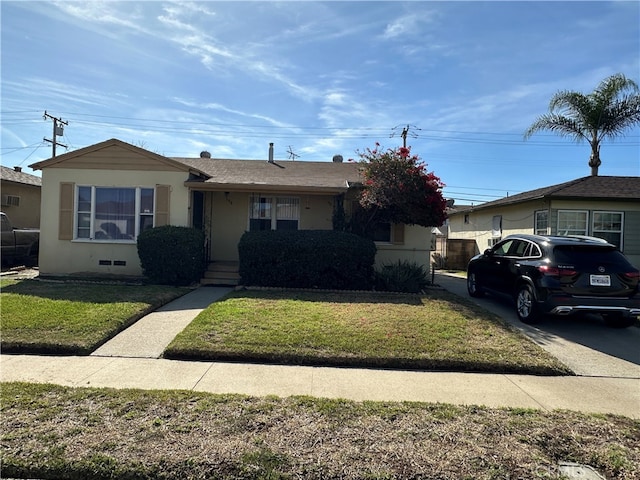 single story home with a front lawn and stucco siding