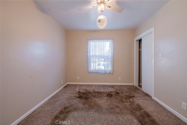 interior space with carpet floors, baseboards, and a ceiling fan