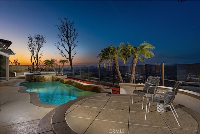 pool featuring an in ground hot tub, a patio area, and fence