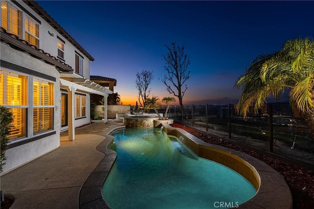 pool at dusk with a patio area, a fenced backyard, a pool with connected hot tub, and a pergola