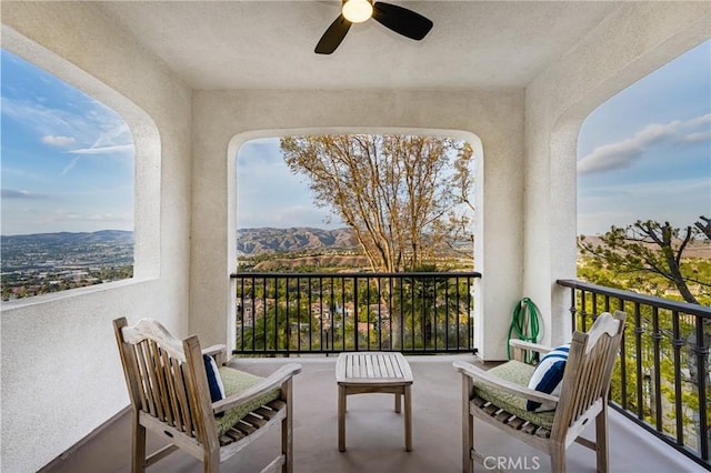 balcony with a ceiling fan and a mountain view