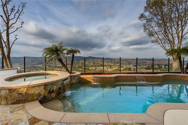 view of pool featuring an in ground hot tub, a mountain view, and pool water feature