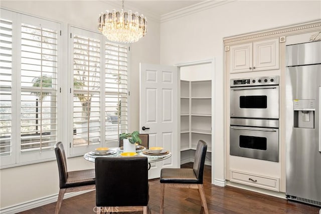 dining area featuring dark wood-style floors, baseboards, ornamental molding, and an inviting chandelier