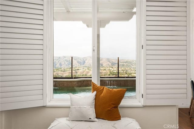 sitting room featuring a mountain view and a healthy amount of sunlight