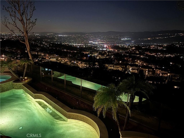 pool at night with an outdoor pool