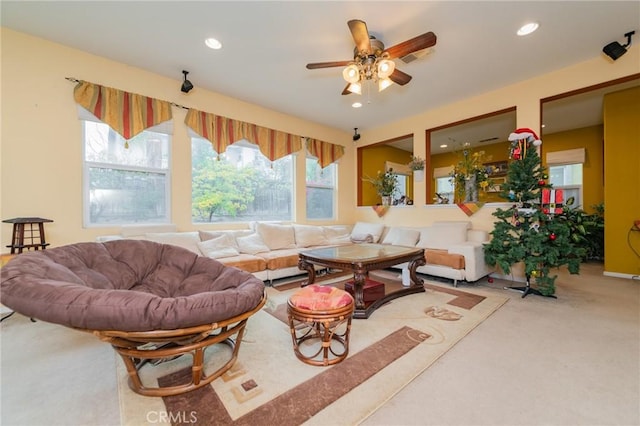 carpeted living room featuring ceiling fan