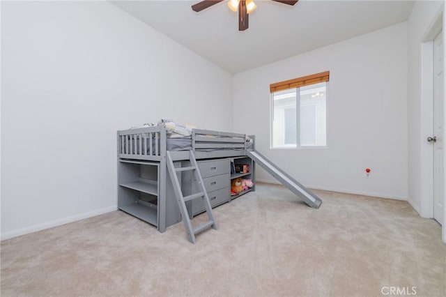 bedroom with ceiling fan, vaulted ceiling, and light carpet