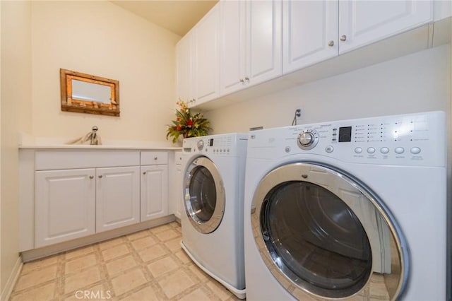 washroom with sink, separate washer and dryer, and cabinets