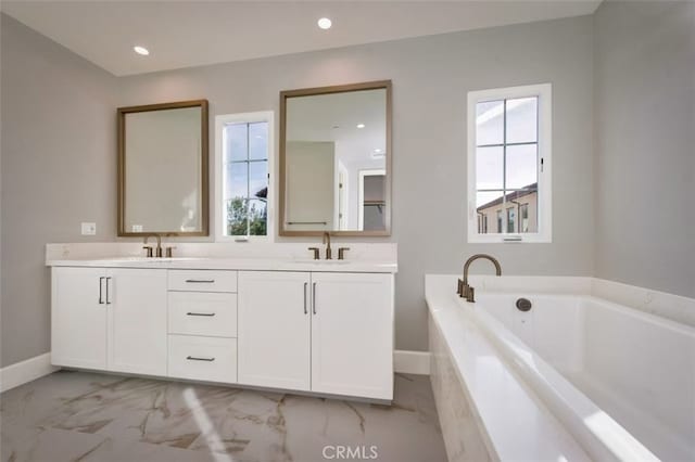 bathroom with a tub to relax in and vanity