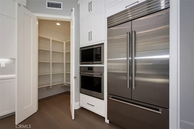 kitchen with white cabinets and built in appliances