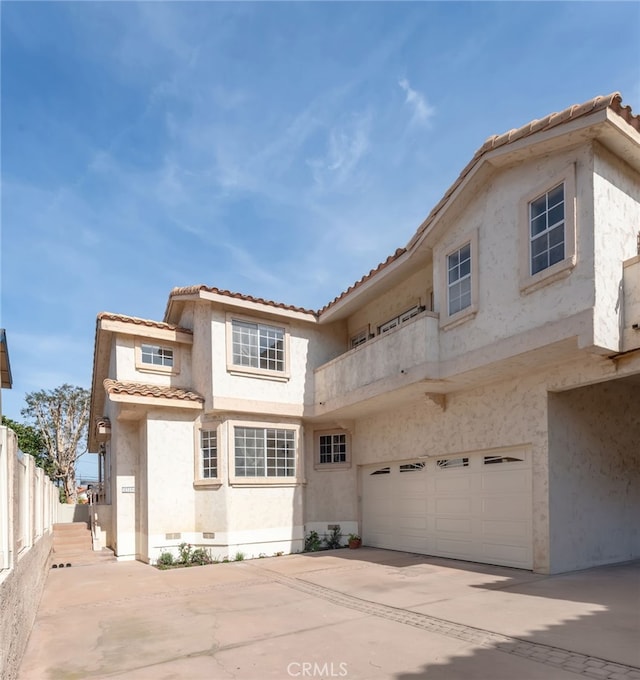 view of front of house featuring a garage, concrete driveway, crawl space, and stucco siding