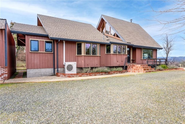 chalet / cabin with ac unit and roof with shingles