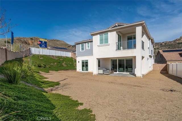 rear view of property featuring a patio and a mountain view