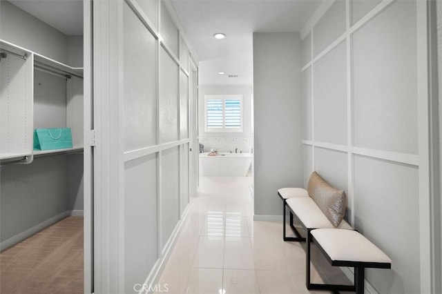 walk in closet featuring light tile patterned flooring