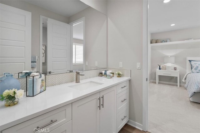 bathroom featuring vanity and tasteful backsplash