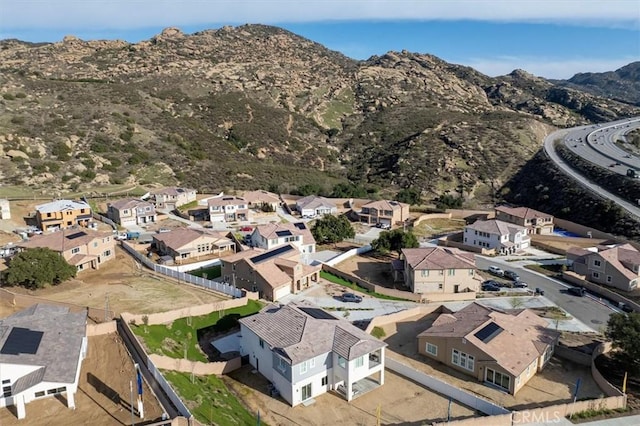 birds eye view of property with a mountain view