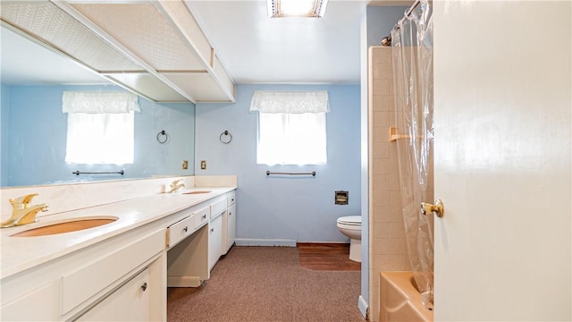 full bathroom featuring toilet, plenty of natural light, vanity, and shower / tub combo