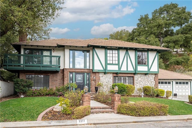 tudor home featuring a front lawn