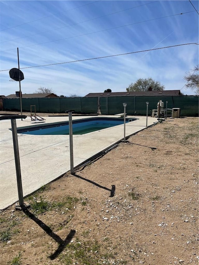 view of swimming pool with a patio area, fence, and a fenced in pool