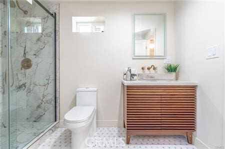 bathroom featuring sink, toilet, and a shower with door