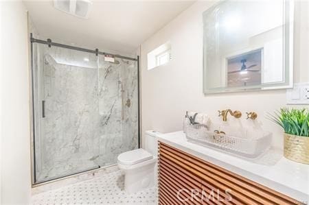 bathroom with tile patterned flooring, sink, a shower with door, and toilet