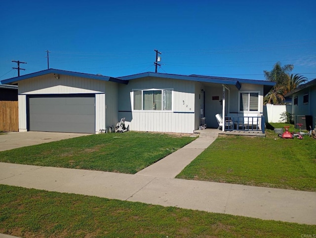 view of front of property featuring covered porch, a front lawn, central AC unit, and a garage