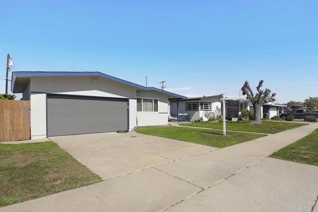 view of front of property with a garage, concrete driveway, and a front yard