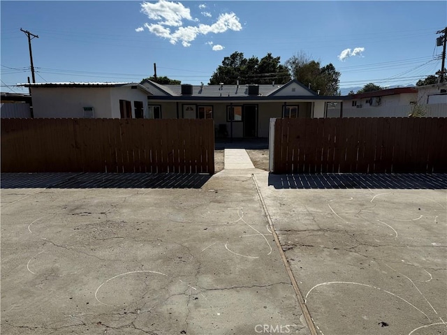 view of front of property featuring a fenced front yard and stucco siding