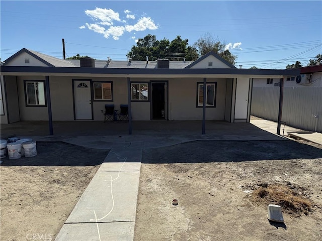 single story home featuring fence