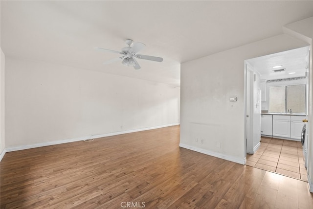 unfurnished room with ceiling fan and light hardwood / wood-style flooring