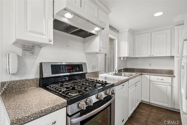 kitchen featuring white cabinetry, sink, dark tile patterned flooring, white dishwasher, and stainless steel gas range