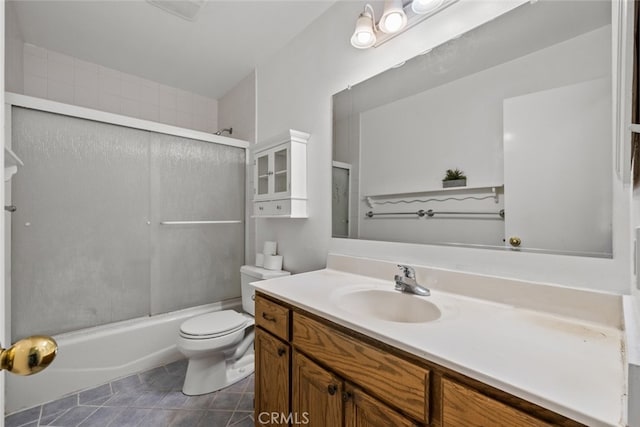 full bathroom featuring vanity, tile patterned flooring, shower / bath combination with glass door, and toilet