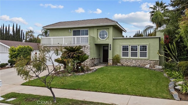 view of front property with a front lawn, a garage, and a balcony