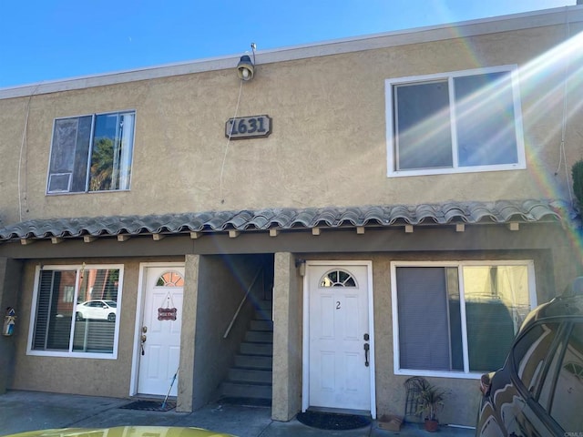 multi unit property with stairway and stucco siding