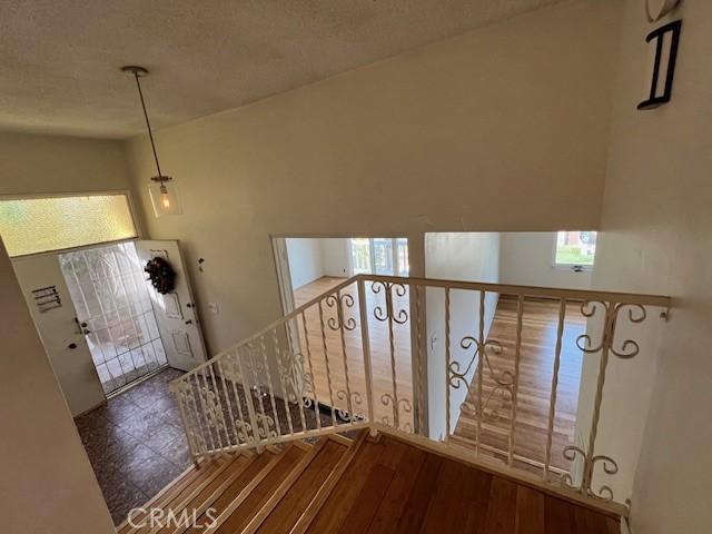 foyer entrance with a textured ceiling