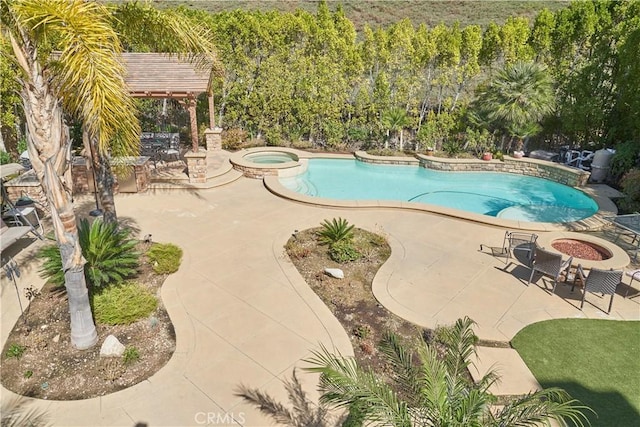 view of swimming pool featuring an in ground hot tub and a patio area