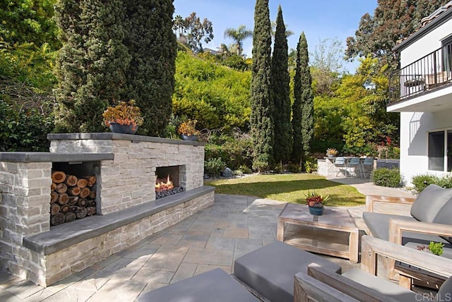 view of patio / terrace featuring an outdoor stone fireplace