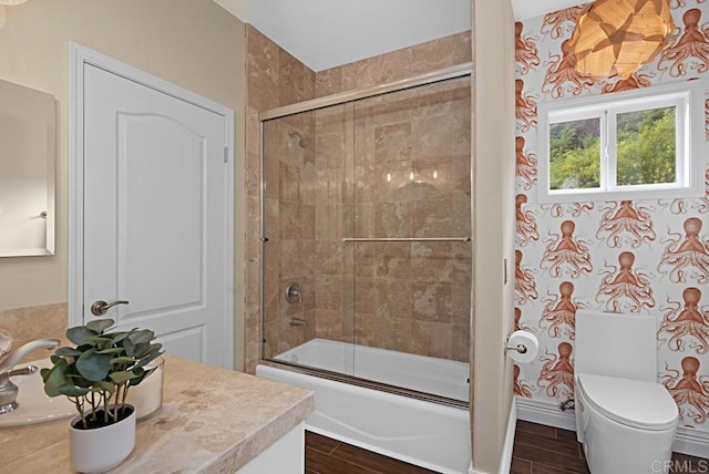 full bathroom with toilet, vanity, and combined bath / shower with glass door