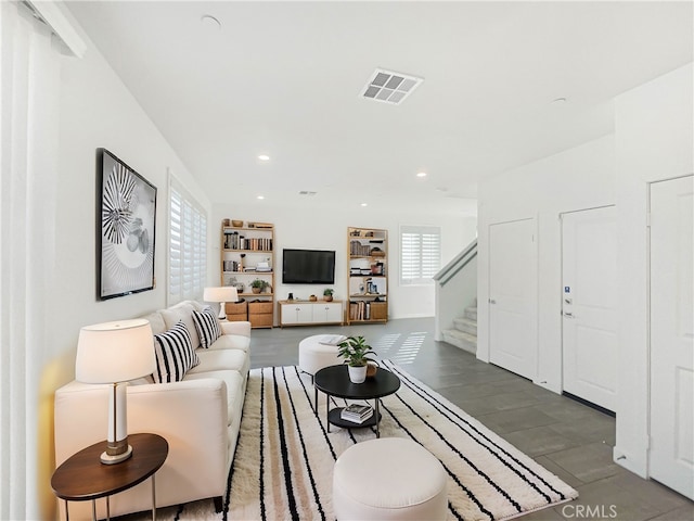 living area with stairway, visible vents, dark wood-style flooring, and recessed lighting