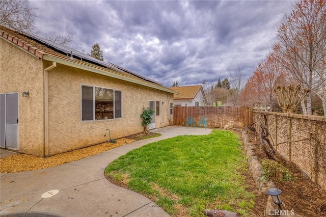 view of yard featuring a patio and a fenced backyard